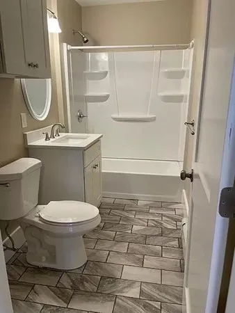 a bathroom with a sink toilet and shower