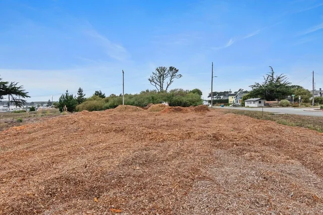 a backyard of a house with a yard and outdoor seating