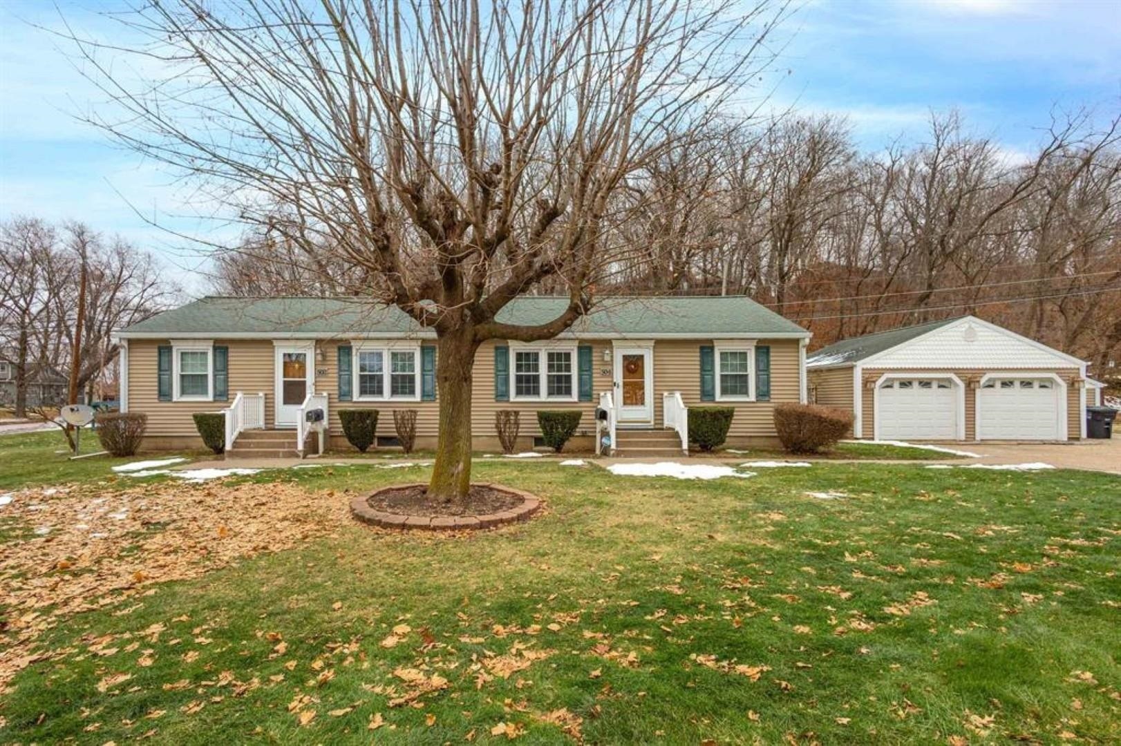 502-504 48th Street Moline, IL 61265 - Photo 1 of 31 a front view of a house with garden yard and trees