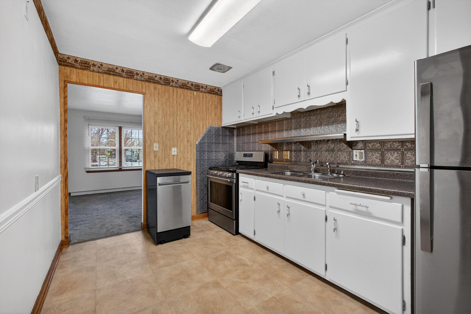 502-504 48th Street Moline, IL 61265 - Photo 11 of 31 a kitchen with granite countertop a sink stove and refrigerator