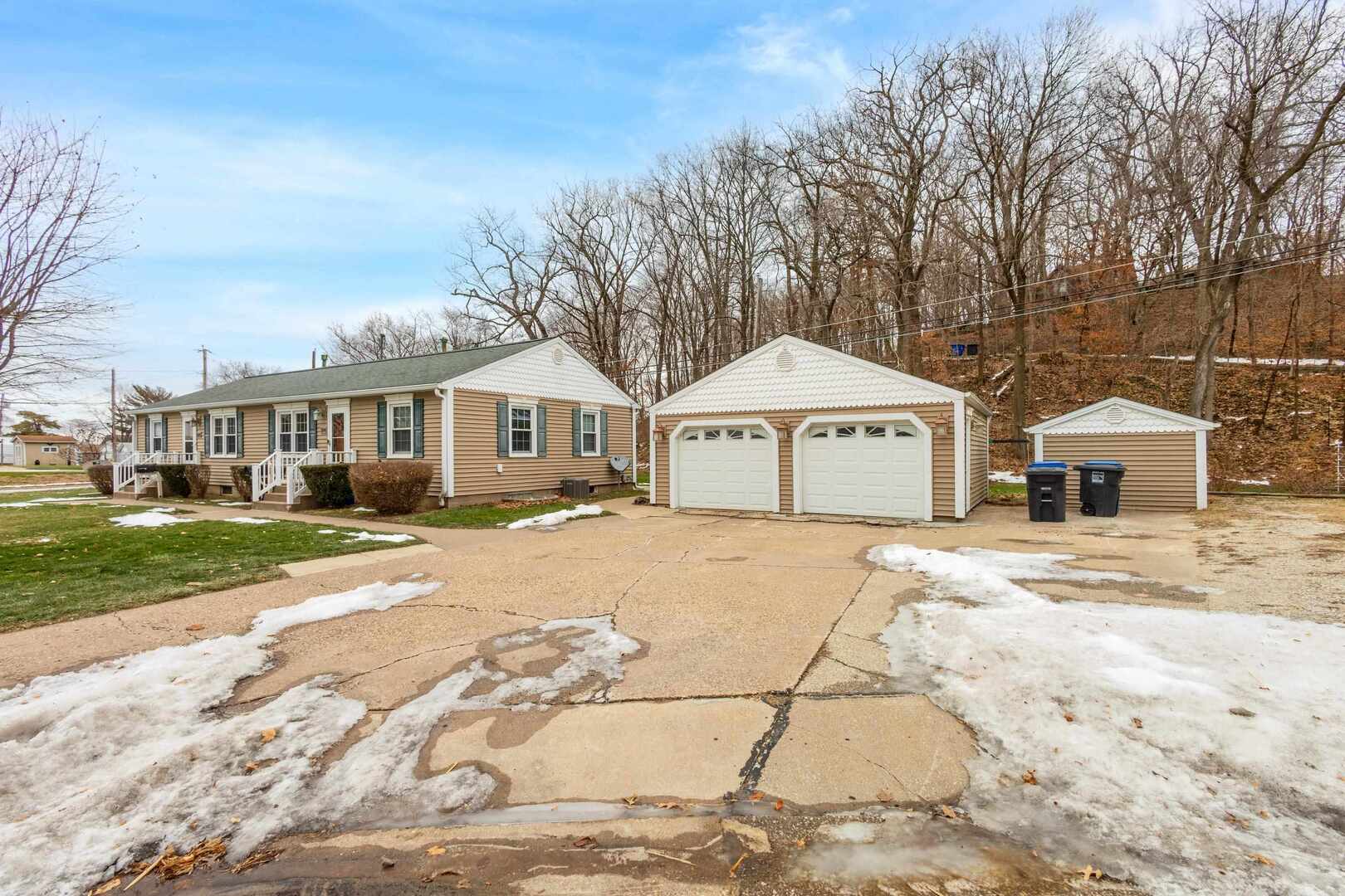 502-504 48th Street Moline, IL 61265 - Photo 3 of 31 a front view of a house with a yard and garage