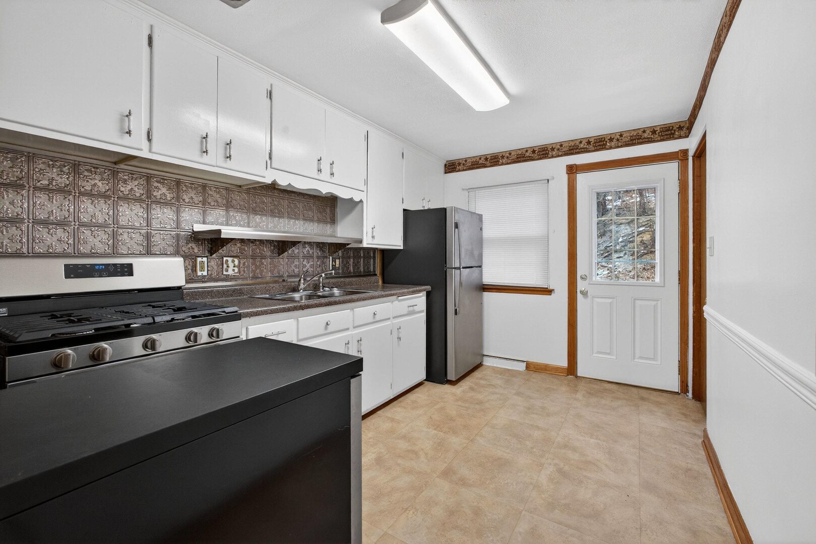 502-504 48th Street Moline, IL 61265 - Photo 9 of 31 a kitchen with stainless steel appliances granite countertop a refrigerator stove and sink