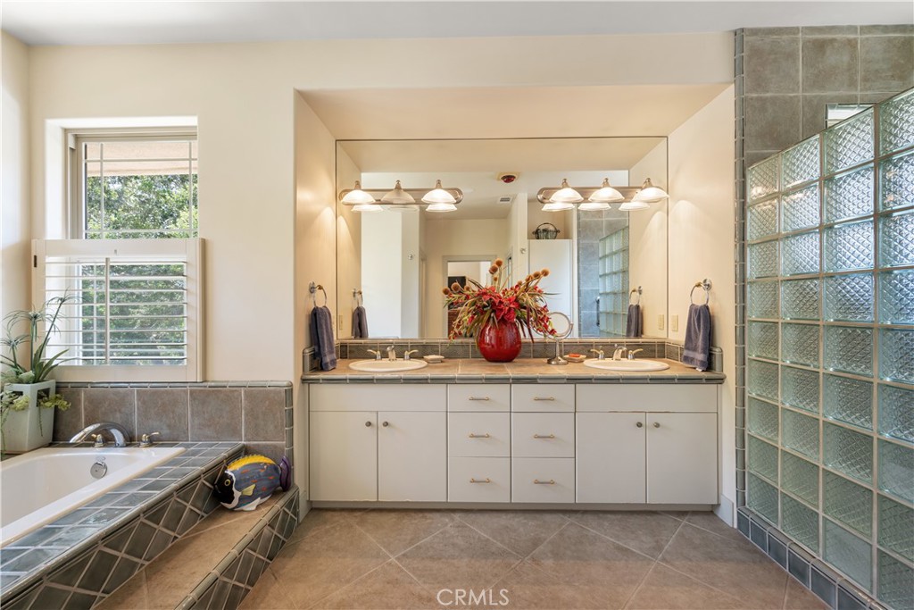 149 Andre Drive Arroyo Grande, CA 93420 - Photo 34 of 67 a en suite bathroom with a double vanity sink a mirror and a bathtub