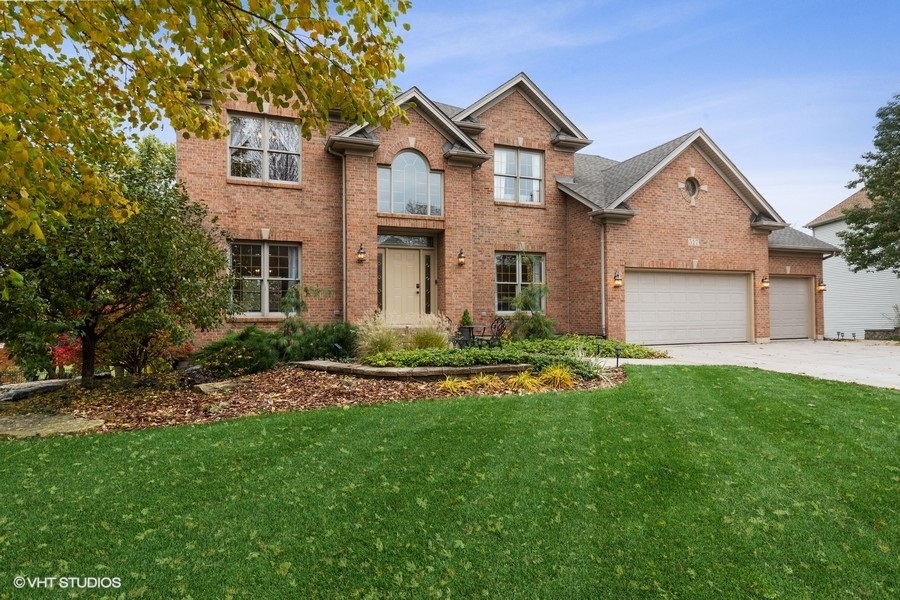 a front view of a house with a yard and garage