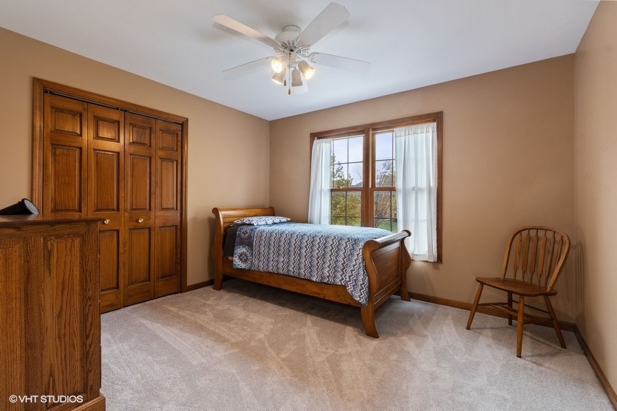 517 Ekman Drive Batavia, IL 60510 - Photo 12 of 22 a bedroom with a bed chair and window