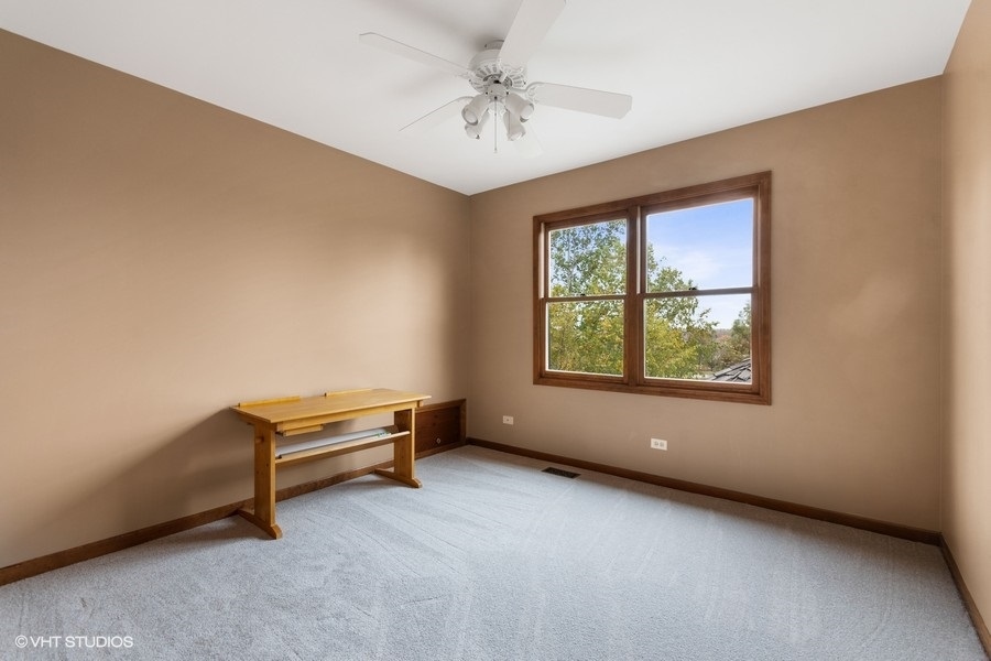 517 Ekman Drive Batavia, IL 60510 - Photo 14 of 22 an empty room with windows and ceiling fan
