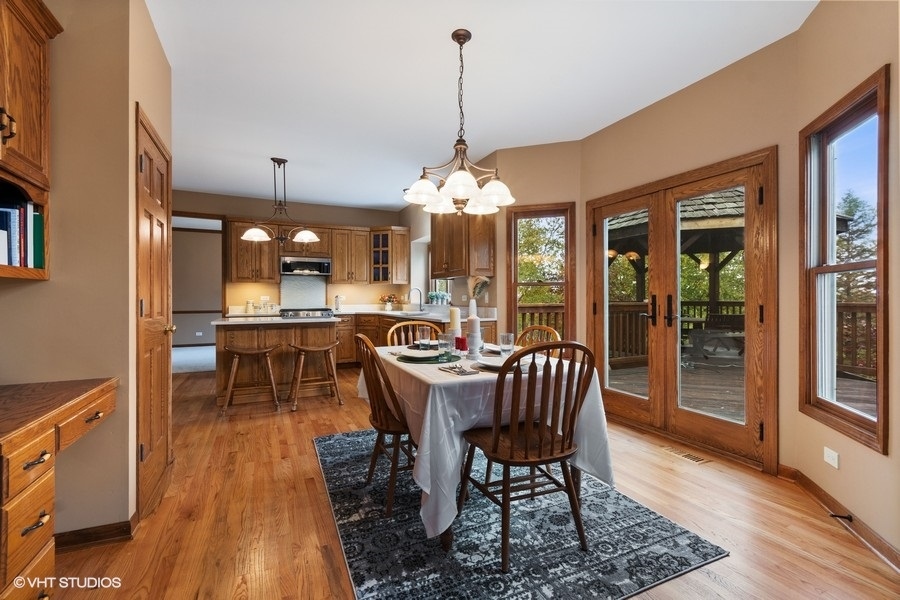 517 Ekman Drive Batavia, IL 60510 - Photo 6 of 22 a dining room with furniture a chandelier and wooden floor