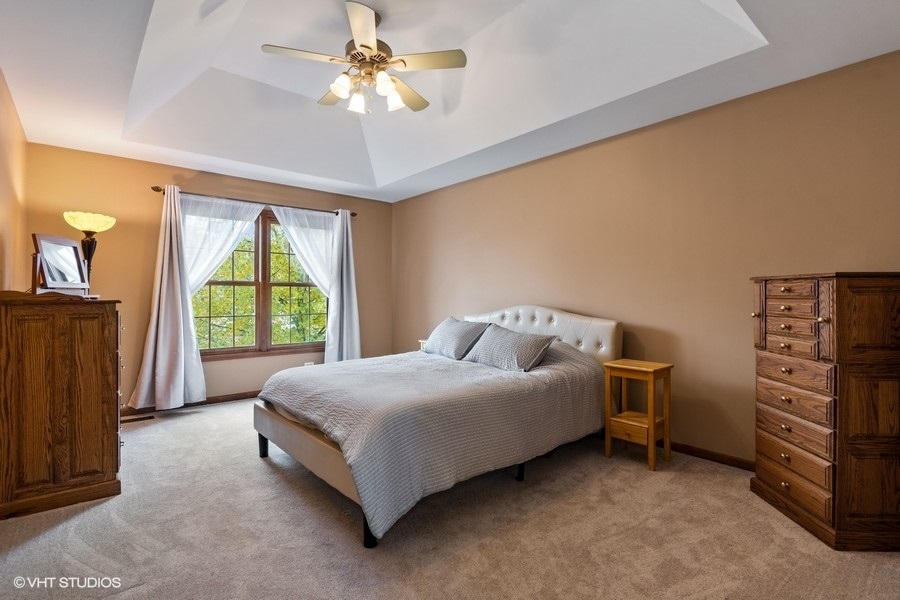 517 Ekman Drive Batavia, IL 60510 - Photo 10 of 22 a spacious bedroom with a bed and a chandelier