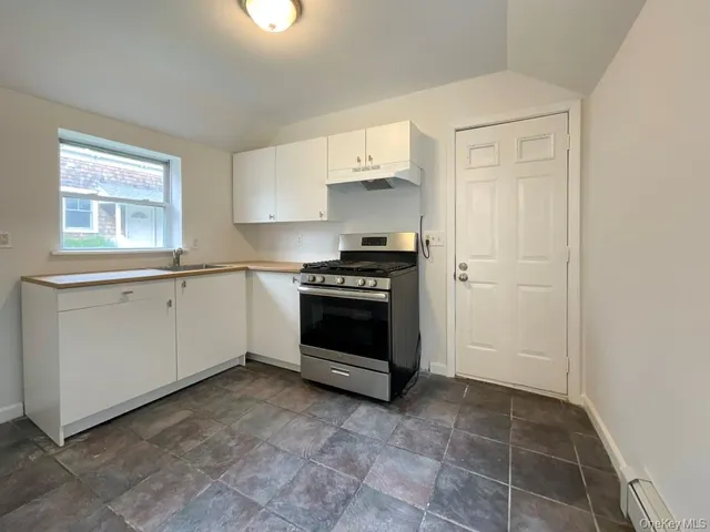 a kitchen with a stove and a refrigerator