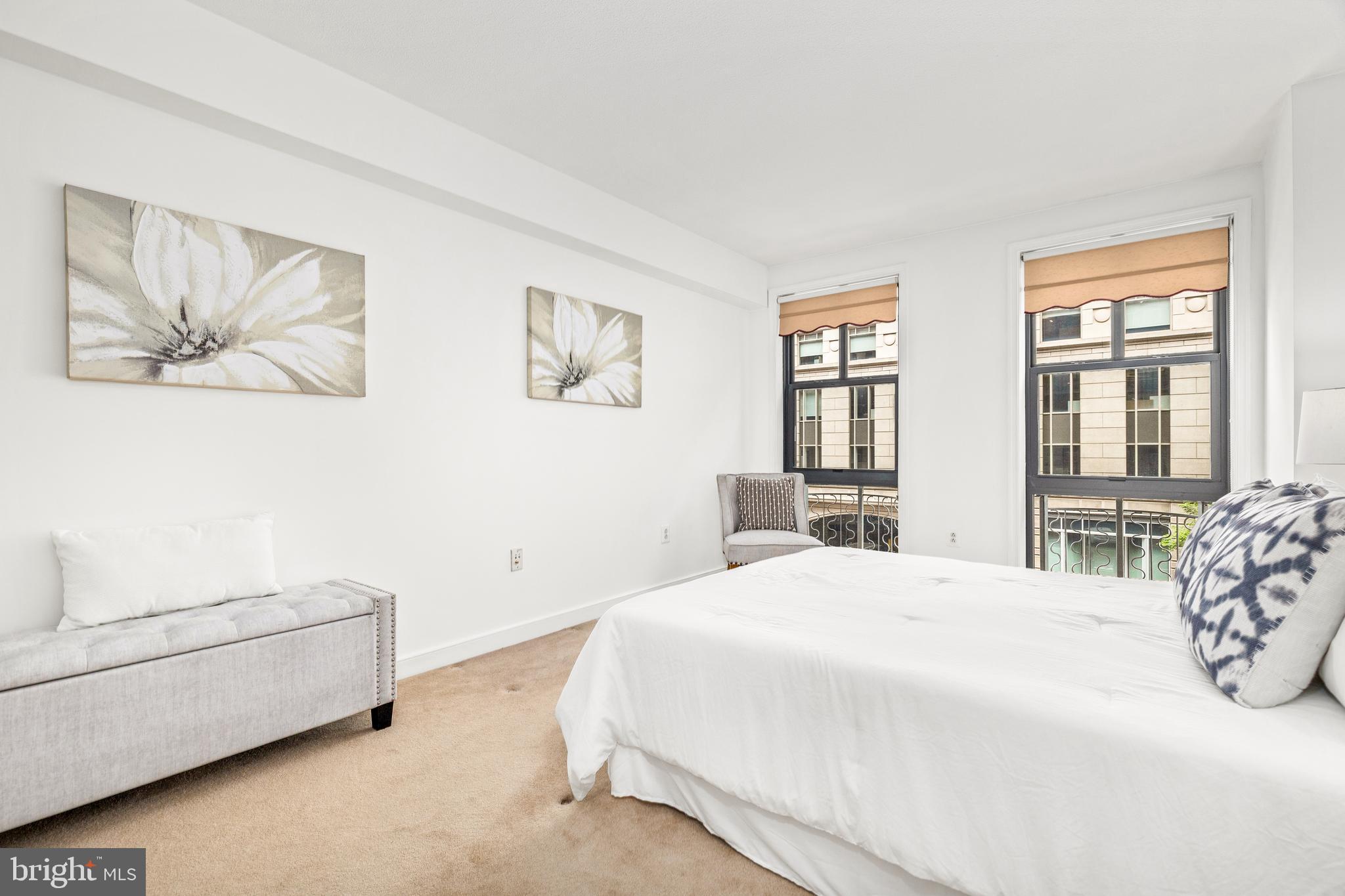 616 E Street Northwest, Unit 322 Washington, DC 20004 - Photo 15 of 33 a bedroom with a bed and a couch