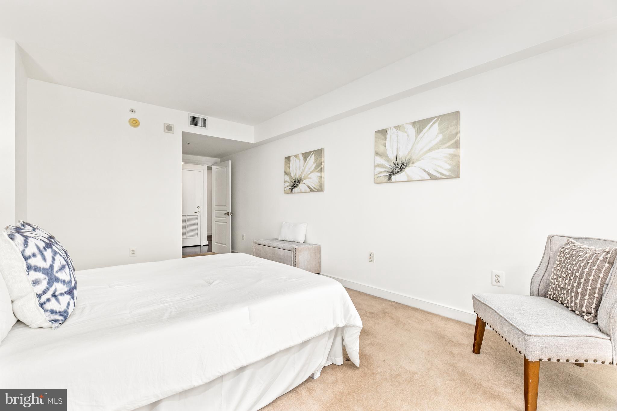 616 E Street Northwest, Unit 322 Washington, DC 20004 - Photo 18 of 33 a bedroom with a bed and a couch