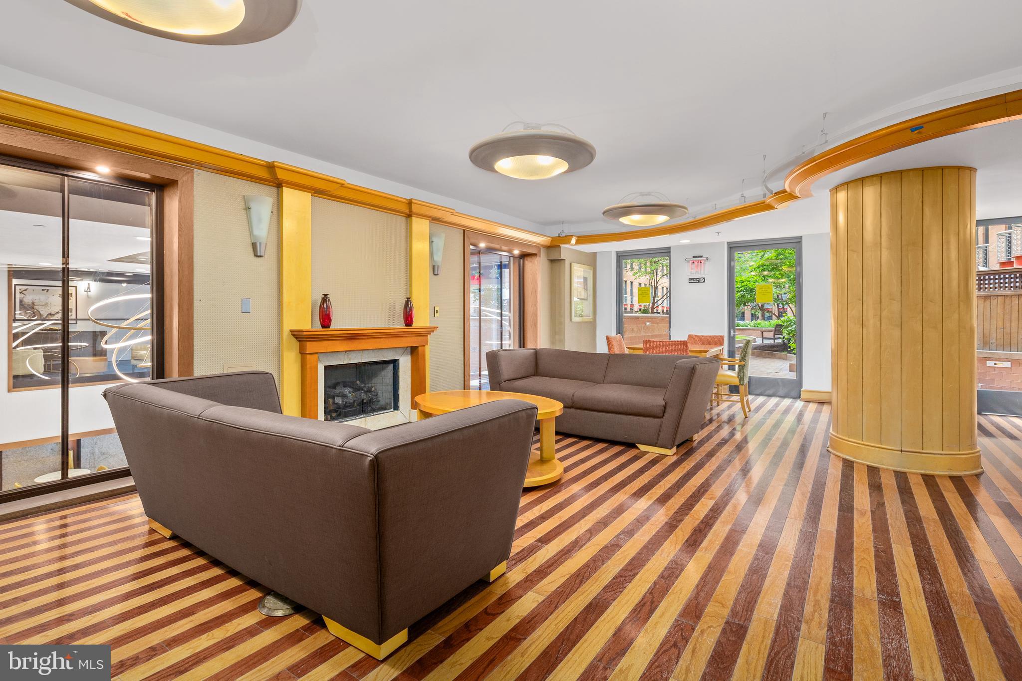 616 E Street Northwest, Unit 322 Washington, DC 20004 - Photo 20 of 33 a living room with furniture and a fireplace