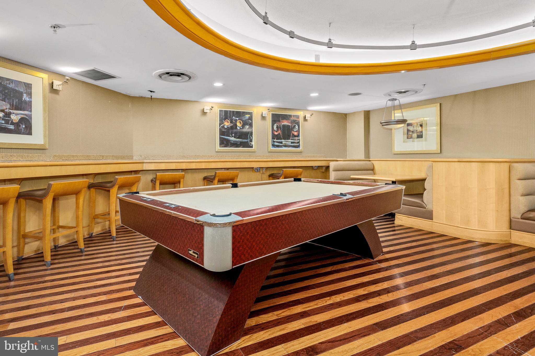 616 E Street Northwest, Unit 322 Washington, DC 20004 - Photo 21 of 33 a room with wooden floor pool table and chairs