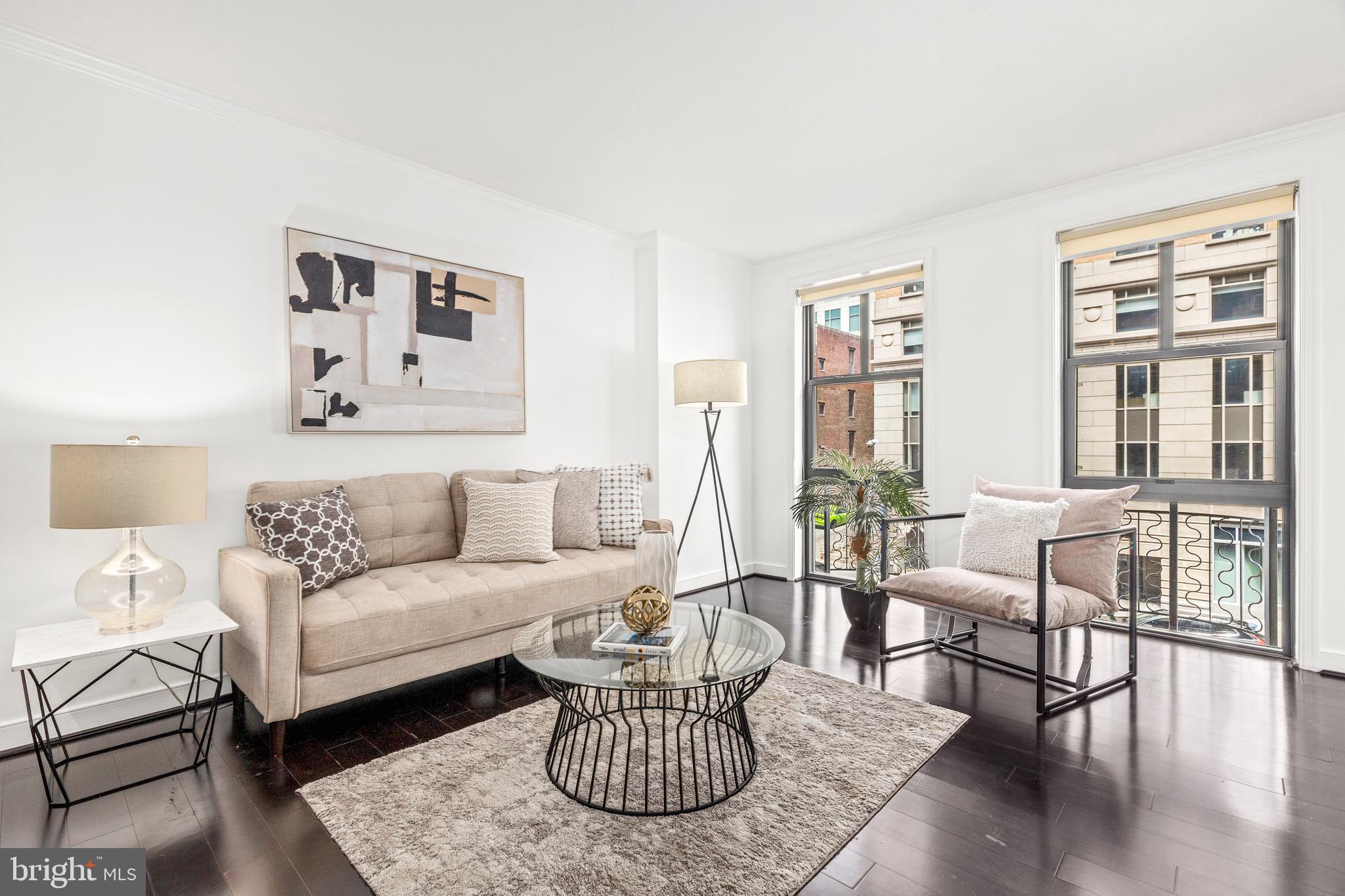 616 E Street Northwest, Unit 322 Washington, DC 20004 - Photo 3 of 33 a living room with furniture and a large window