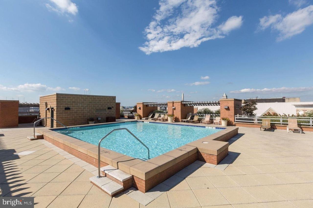 616 E Street Northwest, Unit 322 Washington, DC 20004 - Photo 32 of 33 a living room with furniture and a flat screen tv