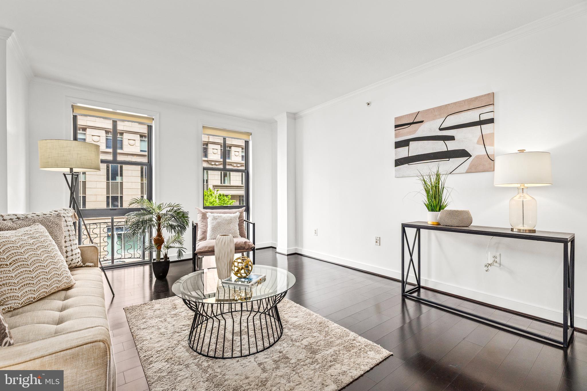 616 E Street Northwest, Unit 322 Washington, DC 20004 - Photo 4 of 33 a living room with furniture and wooden floor