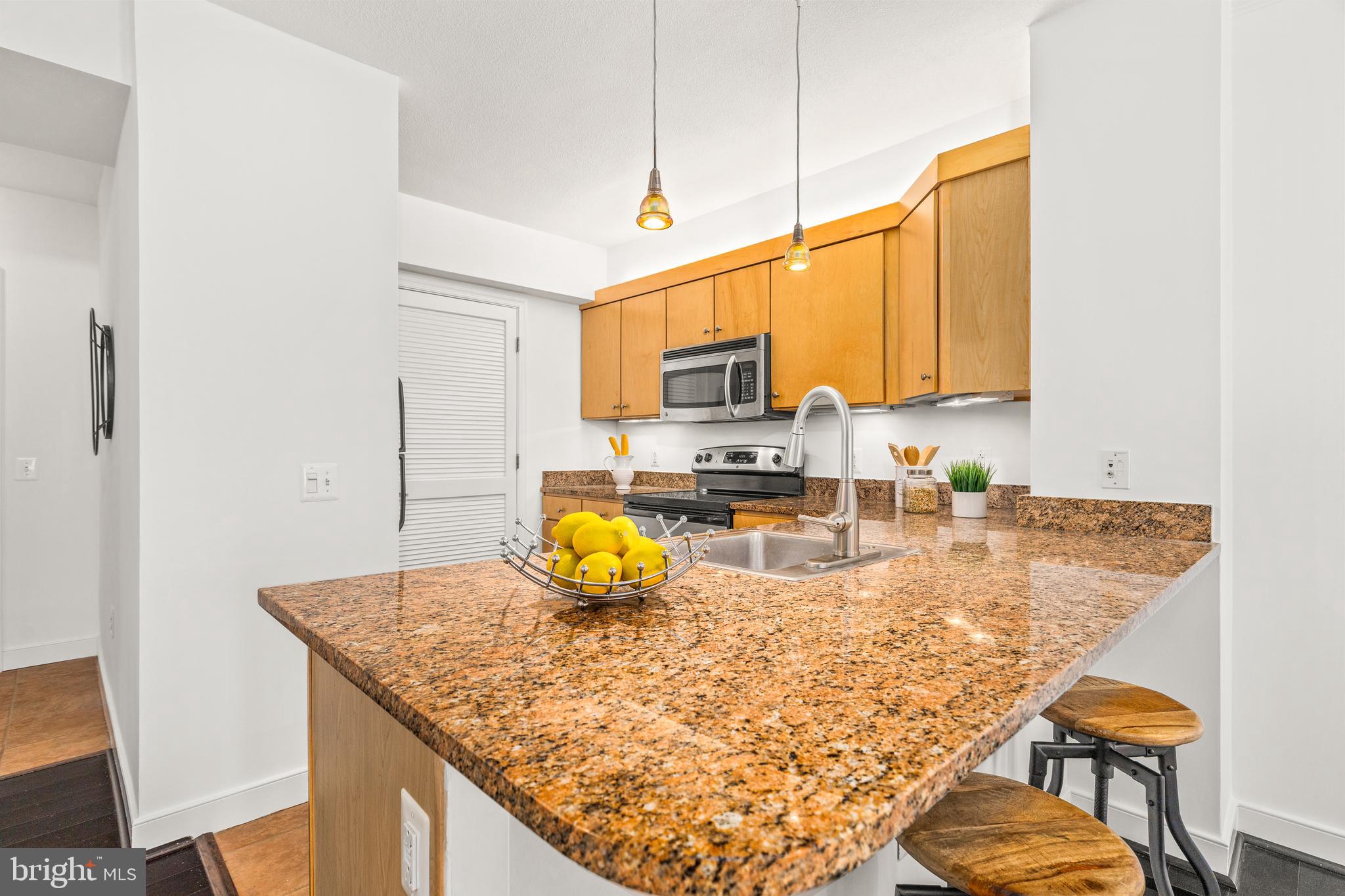 616 E Street Northwest, Unit 322 Washington, DC 20004 - Photo 9 of 33 a kitchen with a sink a counter top space cabinets and appliances