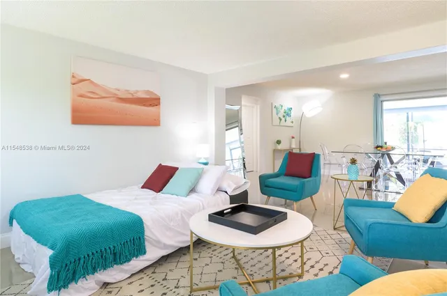 a bedroom with furniture and a wooden floor