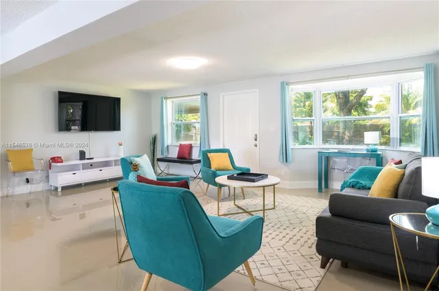 a living room with furniture and a flat screen tv