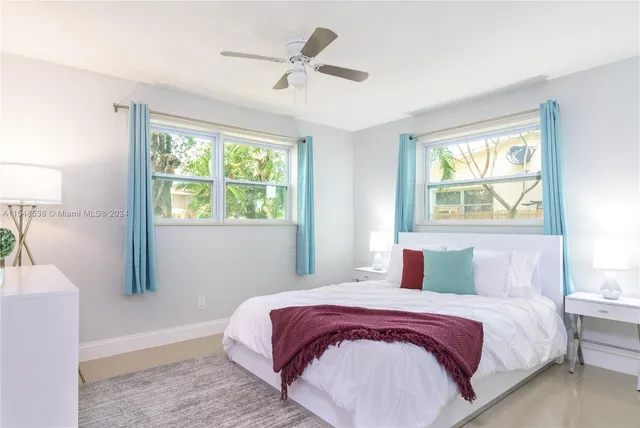 a bedroom with a large bed and a window