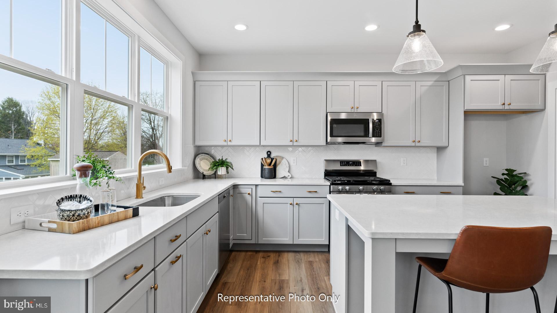 110 Copper Ridge Drive Newmanstown, PA 17073 - Photo 12 of 43 a kitchen with stainless steel appliances granite countertop a stove a sink a microwave a refrigerator and cabinets