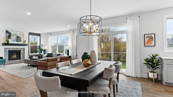 a living room with furniture a fireplace and a chandelier