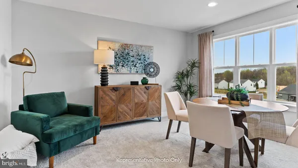 a dining room with furniture and a window