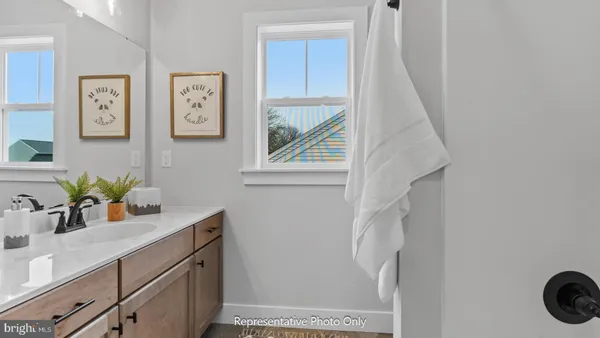 a bathroom with a sink a mirror and vanity