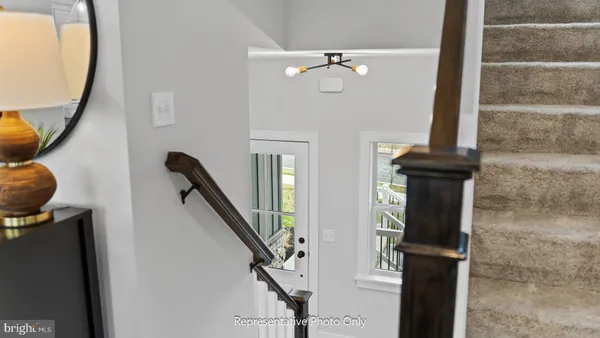 a view of entryway and hall with wooden floor