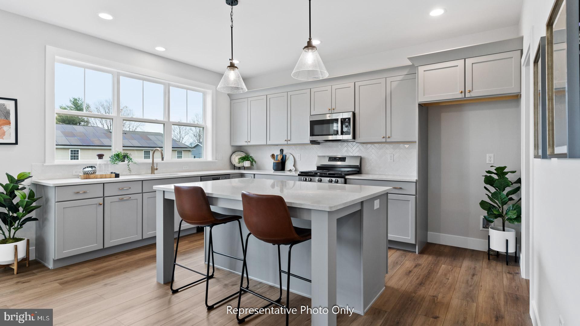 110 Copper Ridge Drive Newmanstown, PA 17073 - Photo 8 of 43 a kitchen with kitchen island granite countertop a sink a counter space appliances and cabinets