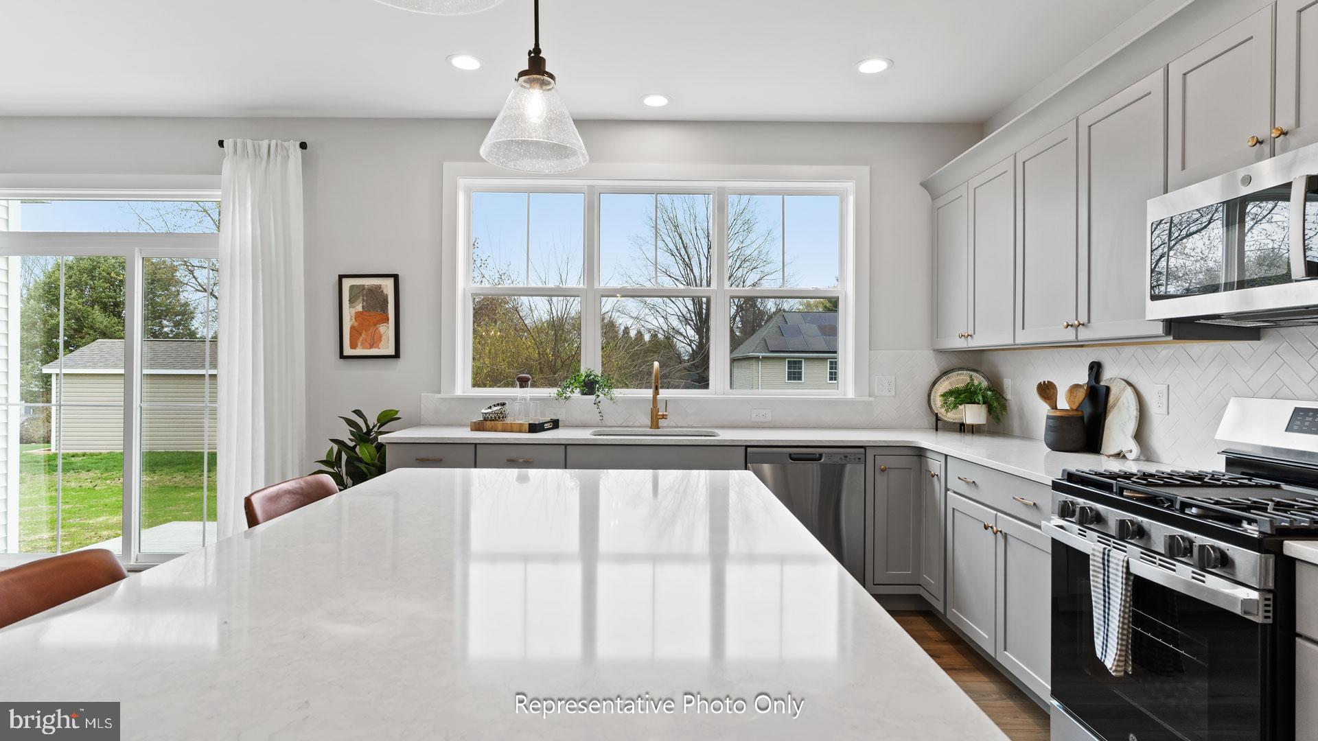 110 Copper Ridge Drive Newmanstown, PA 17073 - Photo 9 of 43 a kitchen with stainless steel appliances granite countertop a stove a sink and a white cabinets