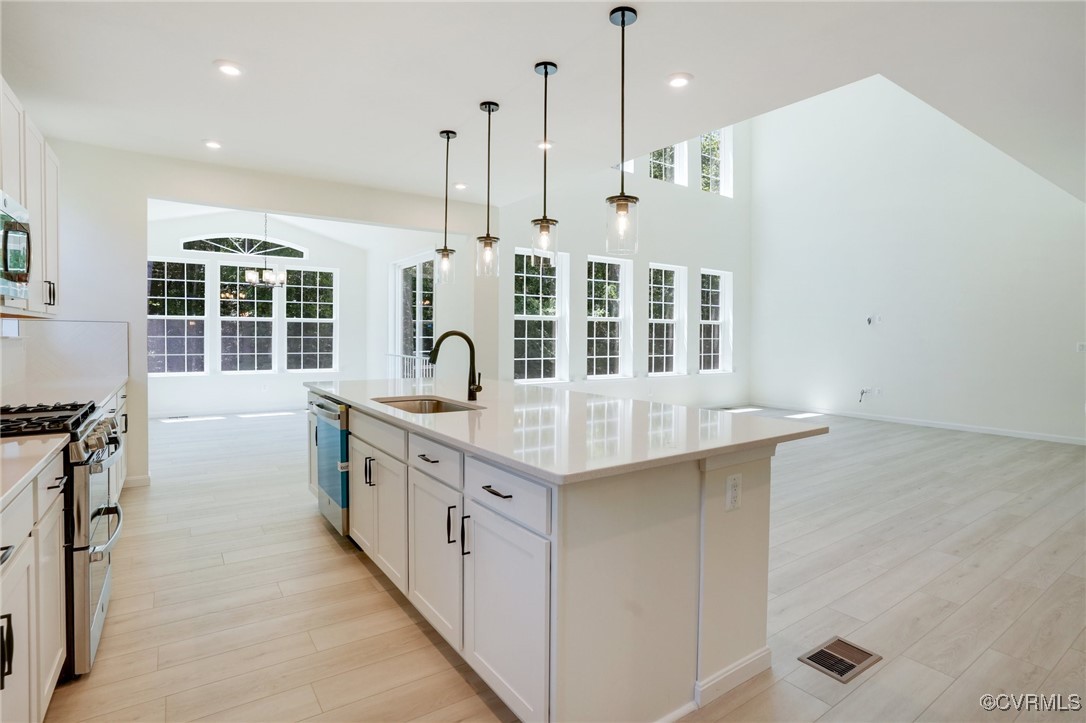 15413 Millwright Road Chesterfield, VA 23832 - Photo 4 of 50 a kitchen with stainless steel appliances granite countertop a stove and a sink