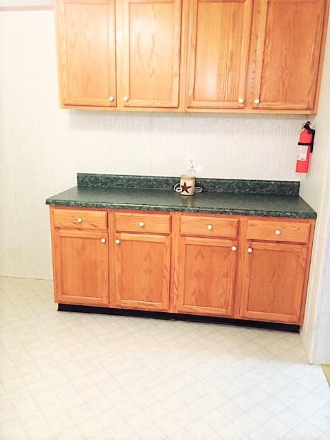 48 L Mitchell Road Kelso, TN 37348 - Photo 19 of 27 a kitchen with granite countertop white cabinets and sink