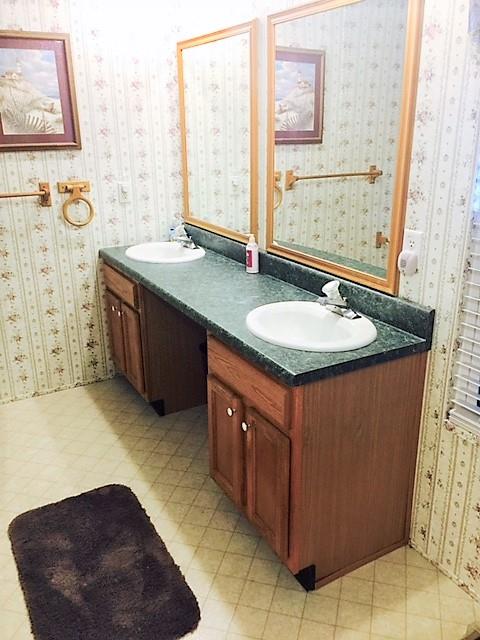 48 L Mitchell Road Kelso, TN 37348 - Photo 24 of 27 a spacious bathroom with a granite countertop sink and a mirror