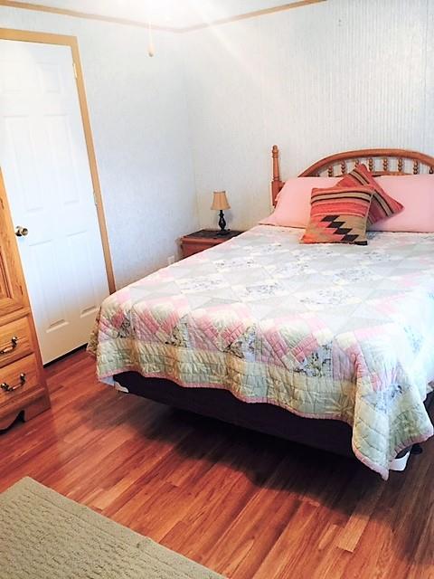 48 L Mitchell Road Kelso, TN 37348 - Photo 26 of 27 a bedroom with a bed and wooden floor