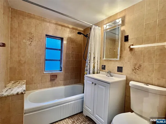 a bathroom with a sink a toilet a bathtub and shower