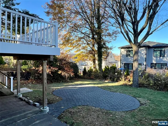 a view of a house with a yard and tree s