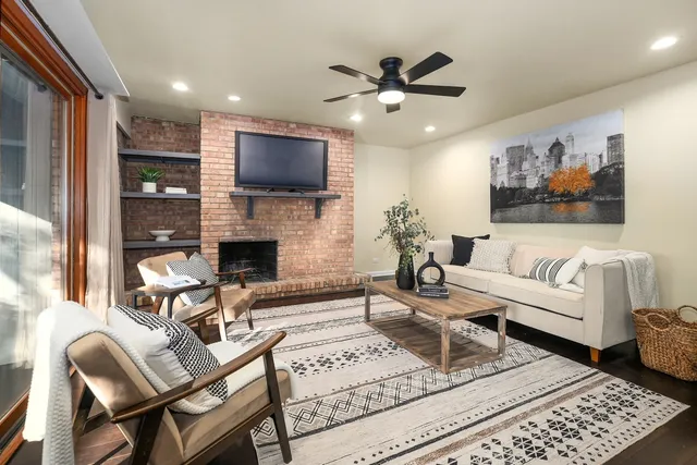 a living room with furniture a flat screen tv and a fireplace