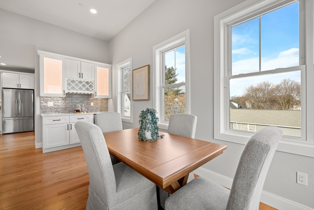 60 Fuller Street, Unit PH5 Boston, MA 02124 - Photo 11 of 32 a view of a dining room with furniture window and wooden floor