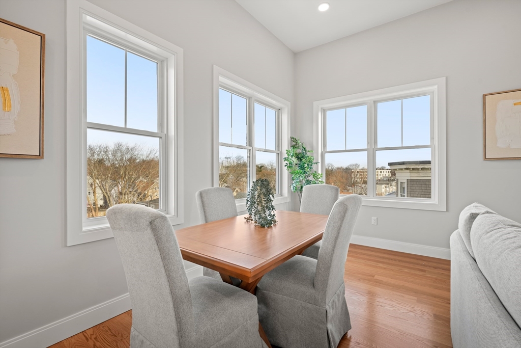 60 Fuller Street, Unit PH5 Boston, MA 02124 - Photo 12 of 32 a dining room with furniture a rug and wooden floor