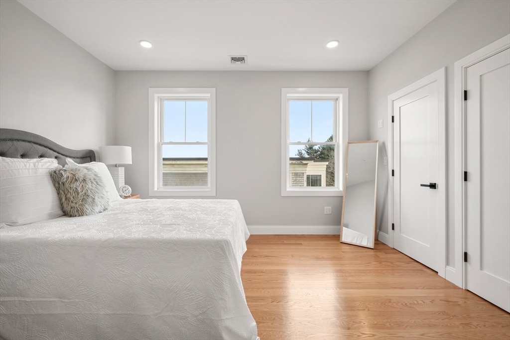 60 Fuller Street, Unit PH5 Boston, MA 02124 - Photo 18 of 32 a bedroom with a large bed and wooden floor