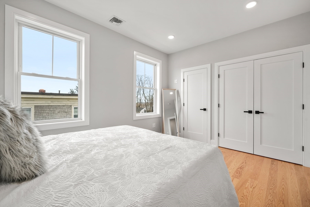 60 Fuller Street, Unit PH5 Boston, MA 02124 - Photo 20 of 32 a large bedroom with a bed and a window