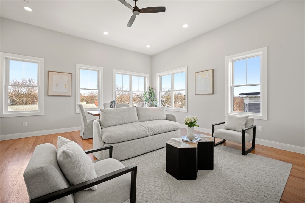 60 Fuller Street, Unit PH5 Boston, MA 02124 - Photo 2 of 32 a living room with furniture and a window