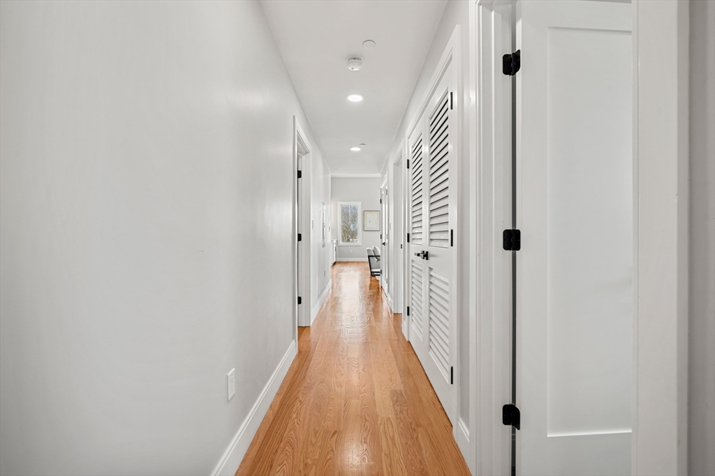 60 Fuller Street, Unit PH5 Boston, MA 02124 - Photo 24 of 32 a view of a hallway with a white walls