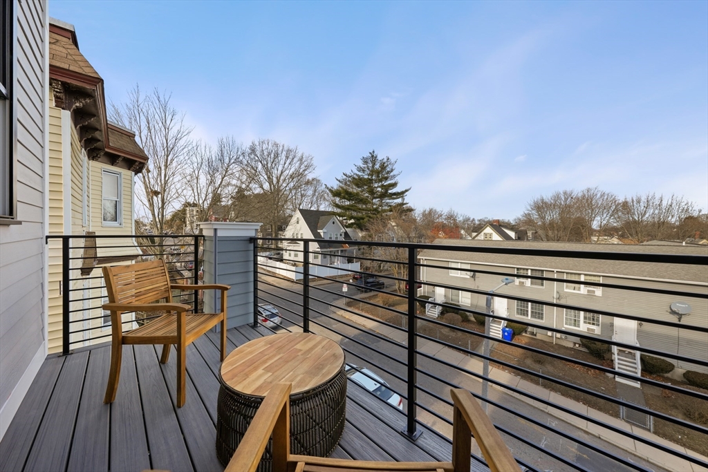 60 Fuller Street, Unit PH5 Boston, MA 02124 - Photo 25 of 32 a view of a balcony with wooden floor and outdoor seating