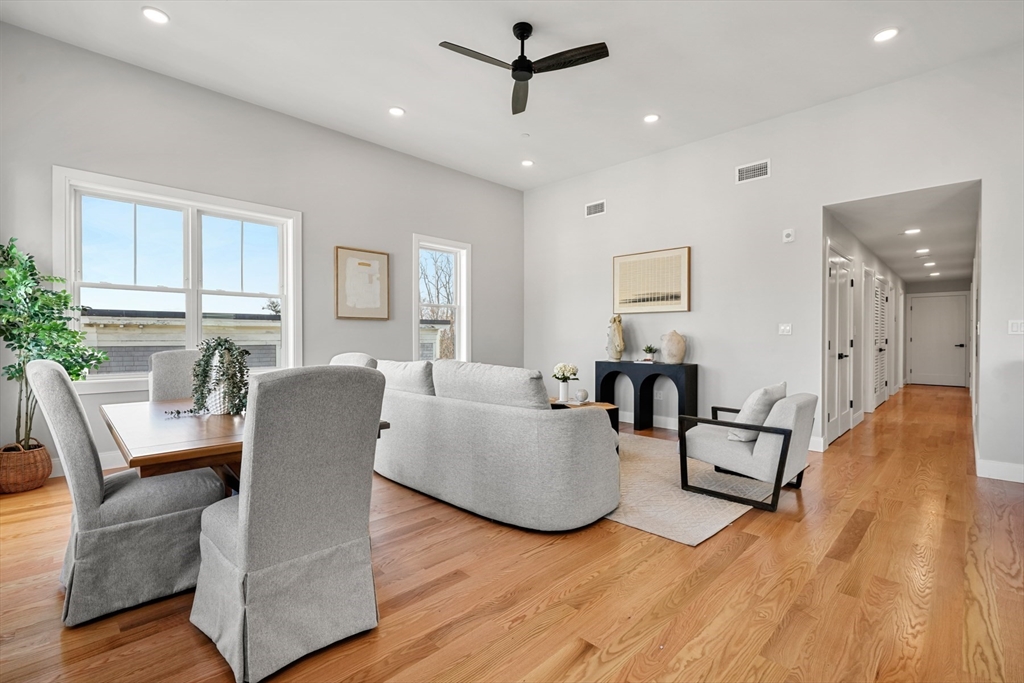 60 Fuller Street, Unit PH5 Boston, MA 02124 - Photo 4 of 32 a living room with furniture and a wooden floor