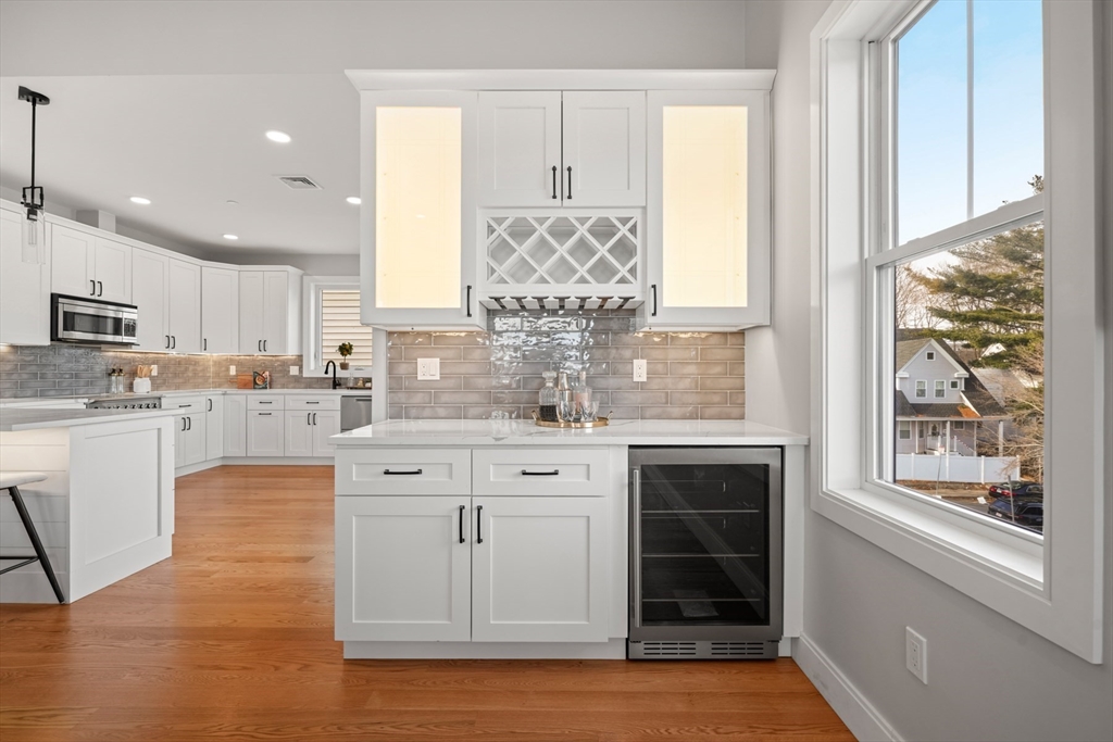 60 Fuller Street, Unit PH5 Boston, MA 02124 - Photo 10 of 32 a large kitchen with kitchen island white cabinets and stainless steel appliances