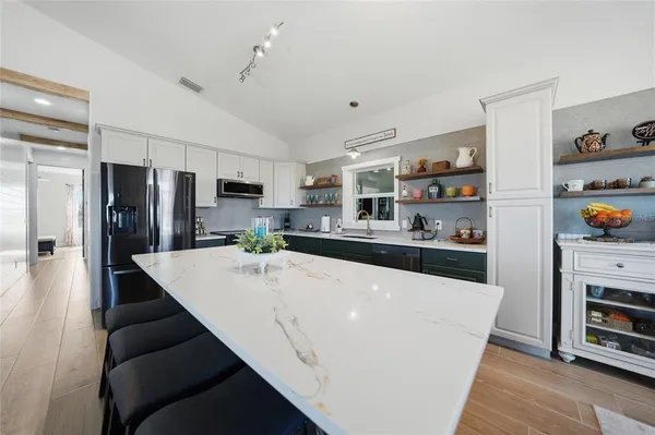 a view of a dining room with furniture a chandelier and wooden floor