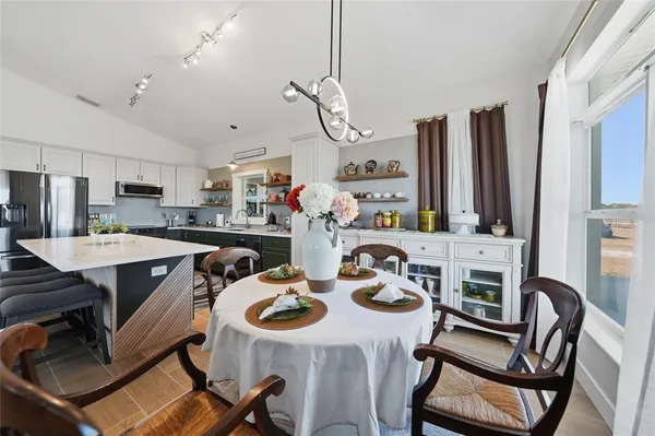 a living room with lots of furniture and a chandelier