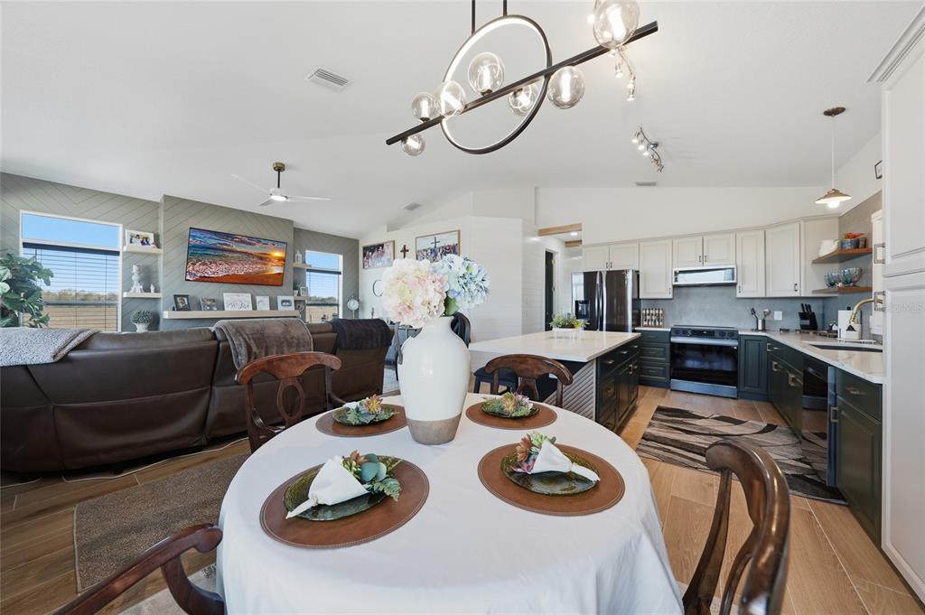 2481 Northeast Faye Terrace Arcadia, FL 34266 - Photo 14 of 57 a living room with lots of furniture and a chandelier